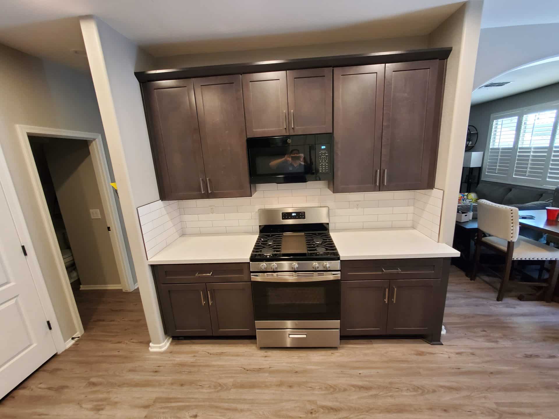 Ahwatukee kitchen with espresso shaker cabinets, white quartz countertops and a white subway tile backsplash